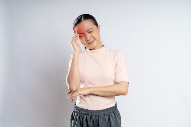 Asian woman was sick with headache standing isolated on white background