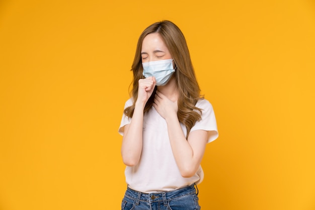 Asian woman wear masks to protect disease on yellow background.