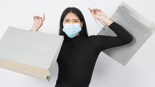 Asian woman wearing face mask hold shopping bag