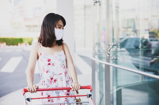 Asian woman wearing a face mask at a shopping place