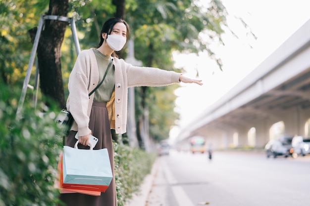 Asian woman wearing a mask while walking on the street