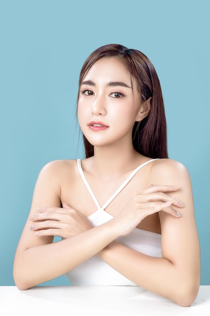 Asian woman with a beautiful face and Perfect clean fresh skin Cute female model with natural makeup and sparkling eyes on white isolated background Facial treatment Cosmetology beauty Concept