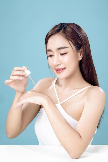 Asian woman with a beautiful face and Perfect clean fresh skin Cute female model with natural makeup and sparkling eyes on white isolated background Facial treatment Cosmetology beauty Concept