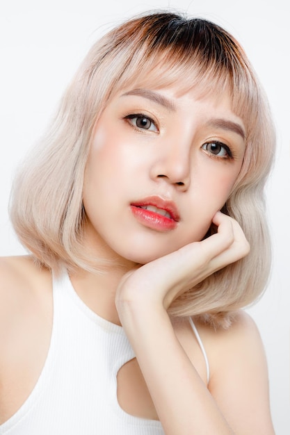 Asian woman with a beautiful face and Perfect clean fresh skin Portrait of female model with natural makeup and sparkling eyes on white isolated background Cosmetology Body care plastic surgery