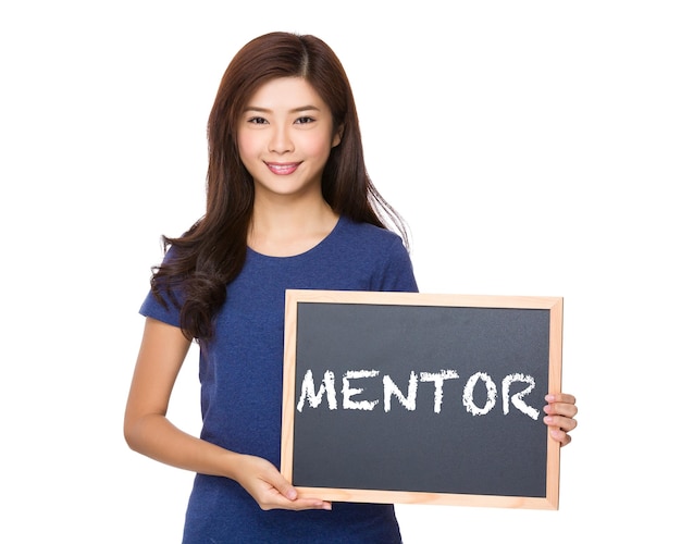 Asian woman with blackboard showing a word of mentor