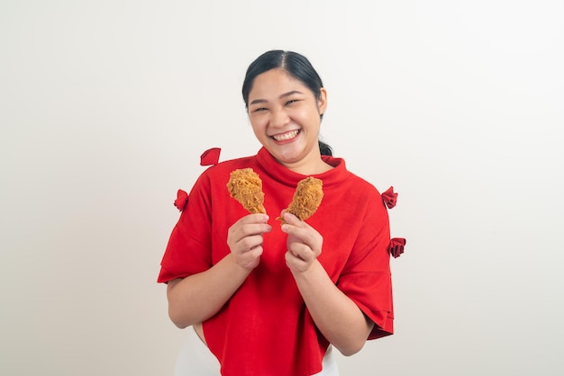 Asian woman with fried chicken on hand