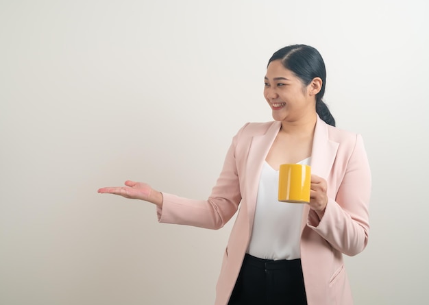 Asian woman with hand holding coffee cup on white background