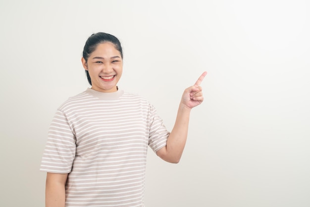 Asian woman with hand pointing on white background