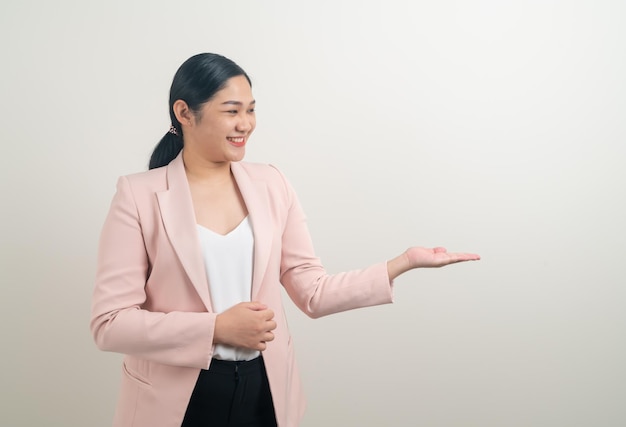 Asian woman with hand present on white wall