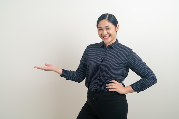 Asian woman with hand present on white wall