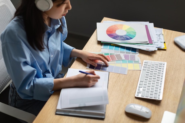 Asian Woman With Headphones Writing Learning Graphic Design Online Indoor