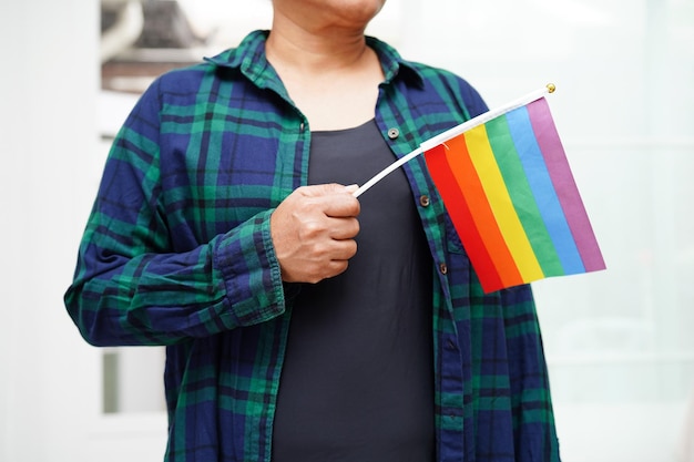 Photo asian woman with rainbow flag lgbt symbol rights and gender equality lgbt pride month in june