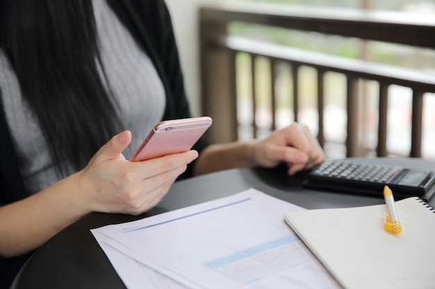  Asian woman with smart phone with business