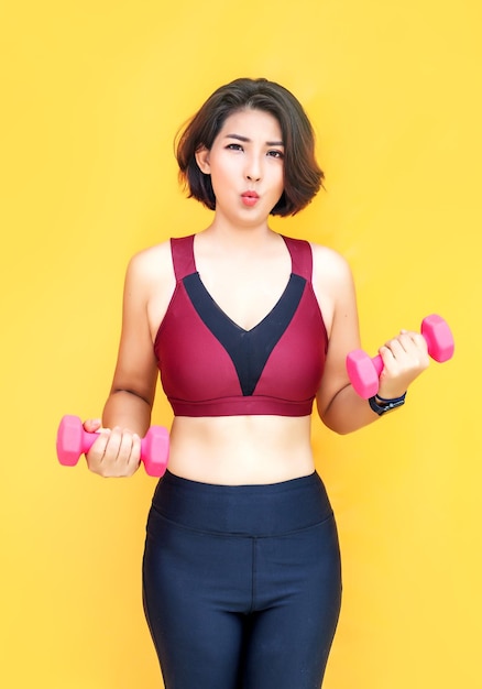 Asian woman work out with dumbbel for wellbeing on isolated