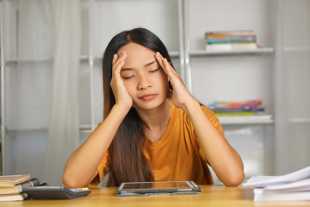 Asian woman working from home Tired of paperwork that is not completed on time