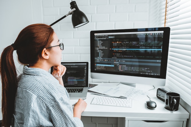 Asian woman working from home using computer