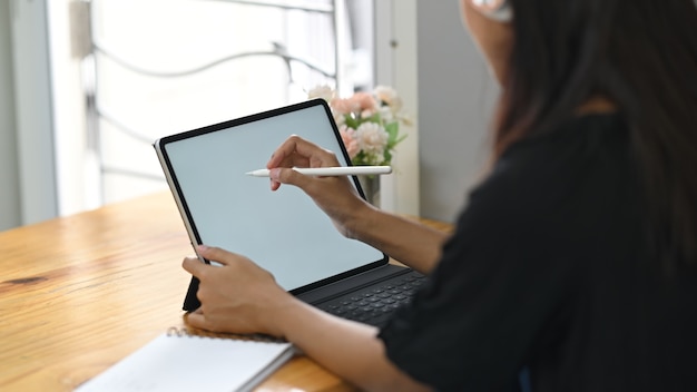 Asian woman working on tablet