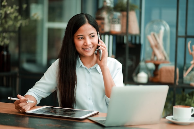 Asian woman working with laptop computer in coffee shop cafe 