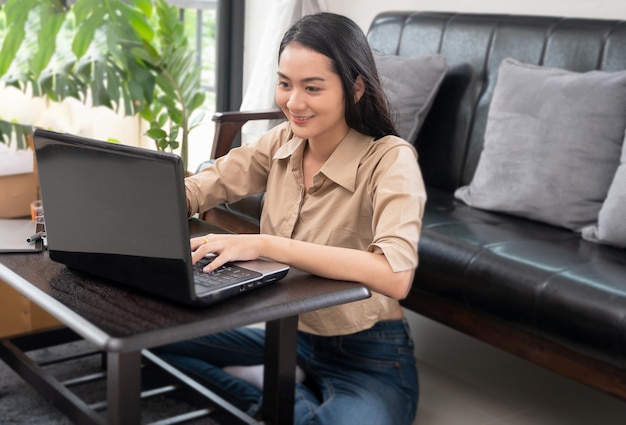 Asian woman works with a computer at home