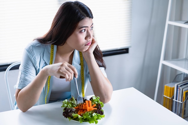 Asian women aiming to lose weight but tired of eating vegetable salad