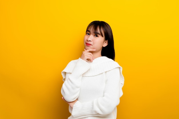 Asian women are cute young cute happy optimistic relaxed good physical health The photo was taken in a yellow backdrop studio