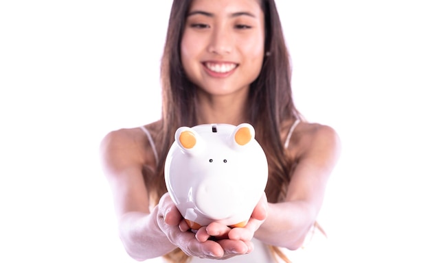 Asian women are saving money in piggy bank