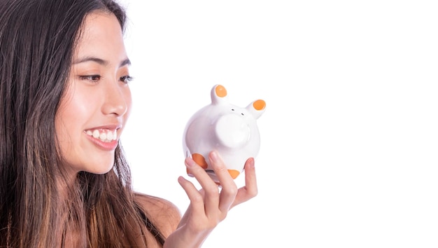 Asian women are saving money in piggy bank