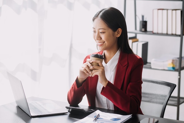 Asian women are stressed while working on laptop Tired asian businesswoman with headache at office feeling sick at work copy space