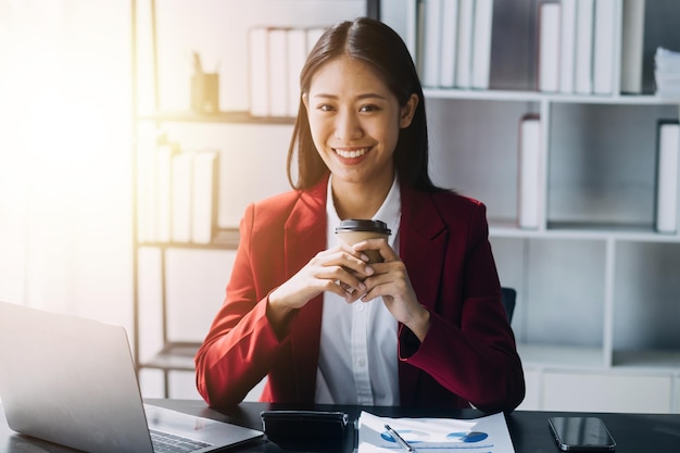 Asian women are stressed while working on laptop Tired asian businesswoman with headache at office feeling sick at work copy space