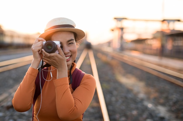 Asian women be smile with camera Travel Holiday Relaxation Concept Vintage Style