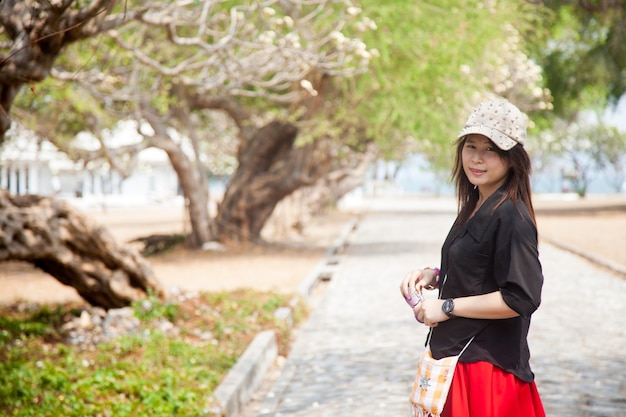 Asian women black shirt Standing on a walkway