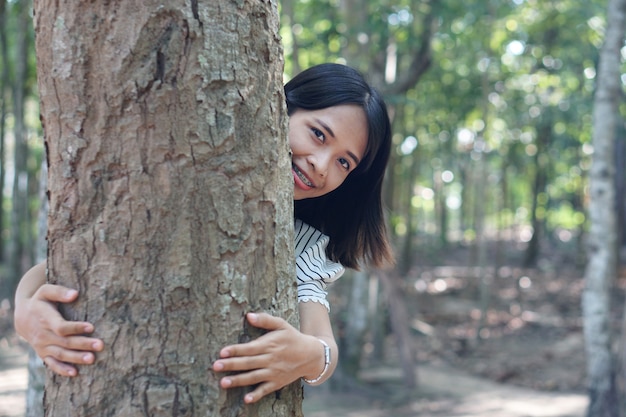 Asian women embrace trees with love, concept of love for the world