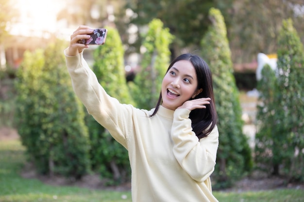 Asian women happy smile  taking photos and Selfie on relaxing time 