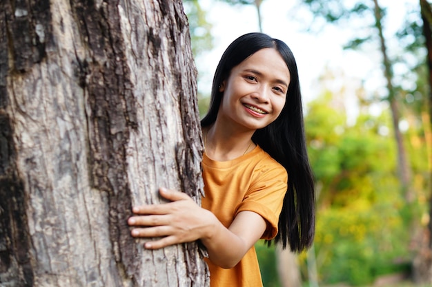 Asian women huging trees the concept of love for the world