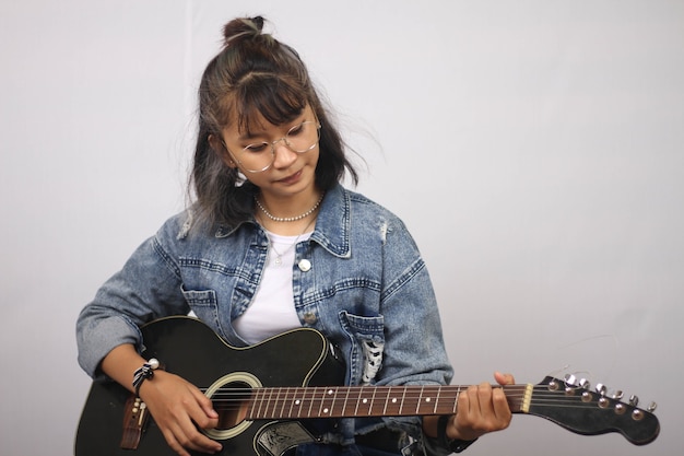 Asian women playing guitar isolated white background