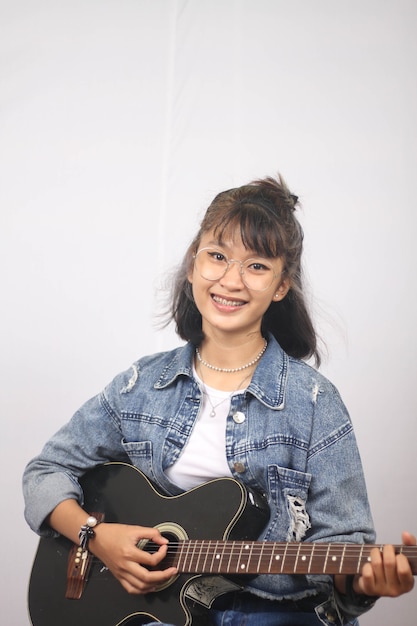 Asian women playing guitar isolated white background