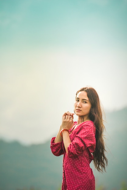 Asian women in red dress on sunrise