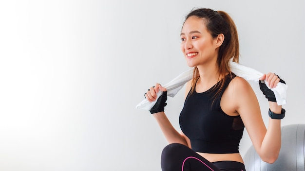 Asian women resting after play yoga and exercise at home background with copy space.