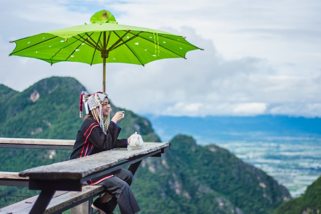 Asian women sit on tea at the top of the mountain. 