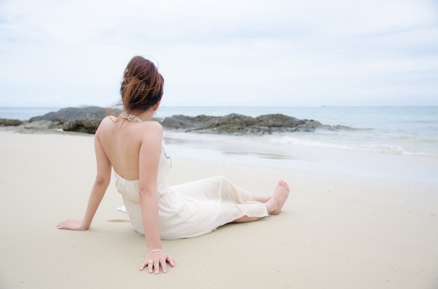 Asian women sitting on sea beach