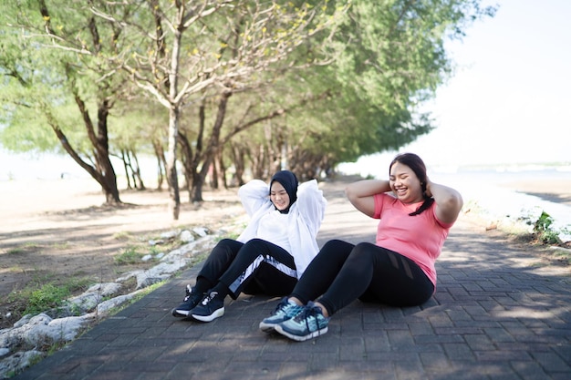 Asian women warming up together before jogging healthy lifestyle concept