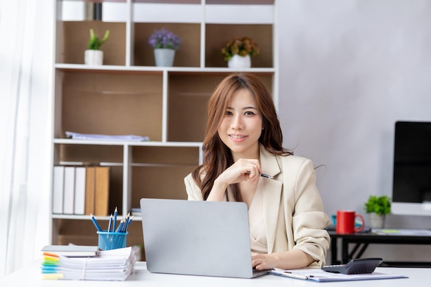 Asian women working in the office young Asian business women as business executives founding and running startup executives young female business leaders Startup business concept