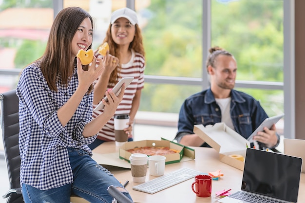 Asian worker  with casual suit talking and eatting with happy action when lunch time