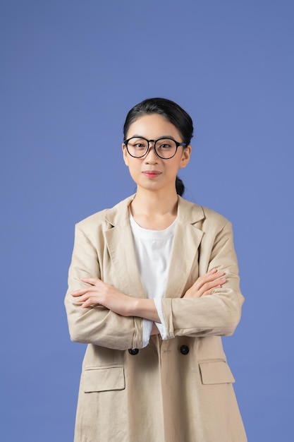 Asian young beautiful female model standing crossed over purple background