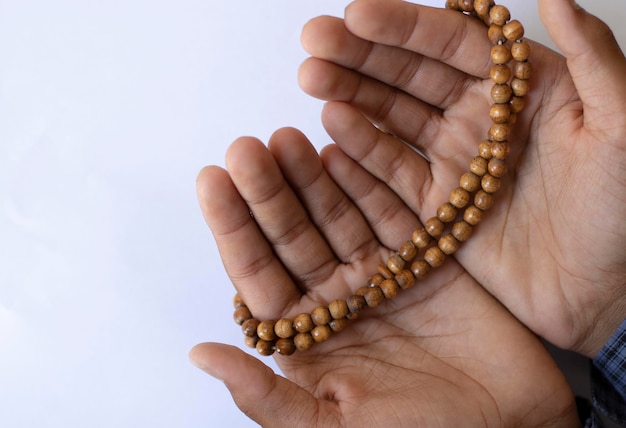 Asian young boy prays with open hands on a white background Boy praying to god