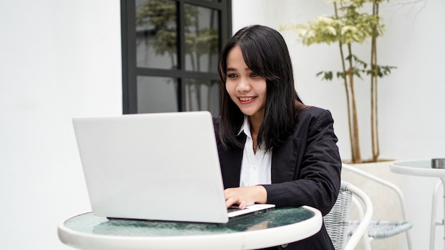 Asian young business woman working on computer in office