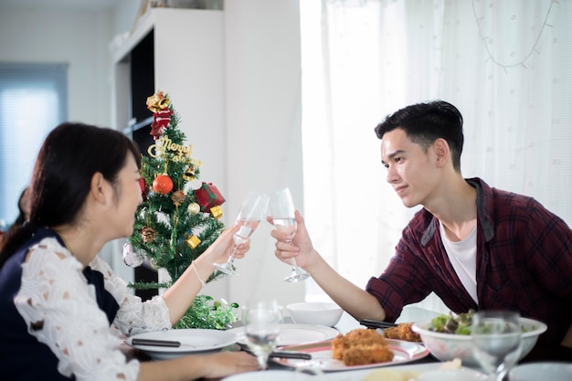 Asian young couple enjoying a romantic dinner  evening drinks while sitting at the dinning table on 