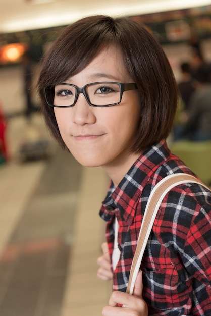 Asian young girl at street in modern city.