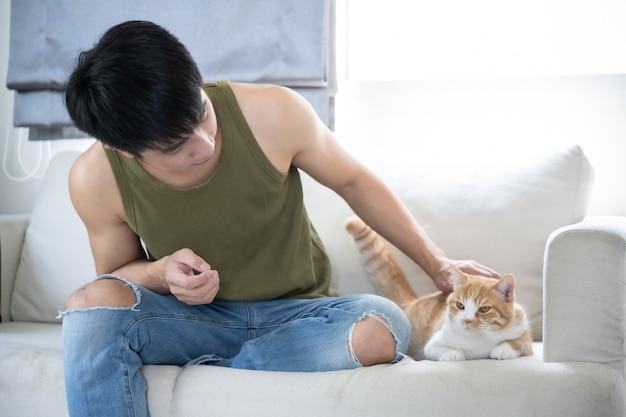 Asian young handsome man and cat