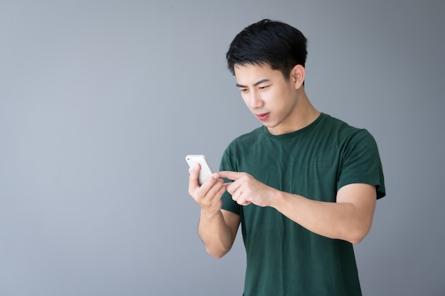 Asian young handsome man using smartphone